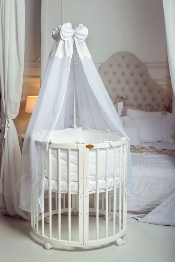 КРОВАТКА- ТРАНСФОРМЕР "COMFORT BABY" .Цена: 25 000 руб.  ХАРАКТЕРИСТИКИ:  возраст детей: 0-5 лет  габариты модели (Д х Ш х В): 1) колыбельки: 78*76*81 см  2) овальной кроватки: 128*76*81 cм  матрас приобретается отдельно.  максимальная нагрузка: 120 кг  Материал: изготавливается только из настоящего массива бука высшего сорта.  сборка: кровать в разобранном виде, простота сборки, инструкция по сборке на русском языке  продукция сертифицирована  производство: Россия  гарантия: 2 года   Дополнительные характеристики: 4 положения по высоте (расстояние положения дна от пола без колес: 1см, 12см, 37см, 57см; расстояние между отверстиями снизу-наверх: 12см, 15см, 20см.); 3 прутика - съемные.  КОНМПЛЕКТАЦИЯ:  1-я ступень - круглая кроватка  2-я ступень - овальная кроватка  3-я ступень - диванчик  4-я ступень - манеж  5-я и 6-я ступени - 2 кресла и столик  7-я ступень - пеленальный столик  ДОПОЛНИТЕЛЬНЫЕ ОПЦИИ:  Комплект постельный "Classic" +6950 руб.  Комплект постельный "Colorit" + 11990 руб.  Фирменный держатель для балдахина +790 руб.  Комплект цельных матрасов " Холкон"/ "Кокос" (круглый+овальный) +8490 руб  Маятник "ComfortBaby Pendulum" 2 в 1+6990 руб.
