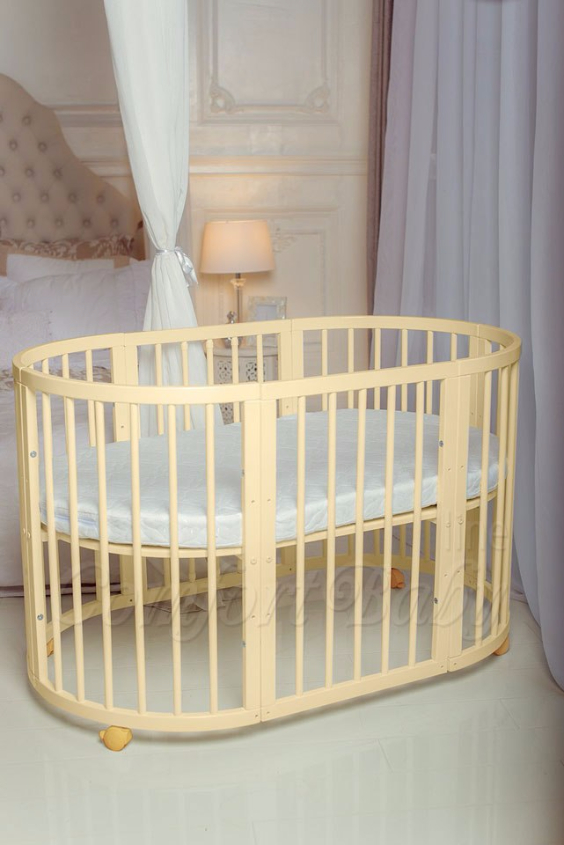 КРОВАТКА- ТРАНСФОРМЕР "COMFORT BABY" .Цена: 25 000 руб.  ХАРАКТЕРИСТИКИ:  возраст детей: 0-5 лет  габариты модели (Д х Ш х В): 1) колыбельки: 78*76*81 см  2) овальной кроватки: 128*76*81 cм  матрас приобретается отдельно.  максимальная нагрузка: 120 кг  Материал: изготавливается только из настоящего массива бука высшего сорта.  сборка: кровать в разобранном виде, простота сборки, инструкция по сборке на русском языке  продукция сертифицирована  производство: Россия  гарантия: 2 года   Дополнительные характеристики: 4 положения по высоте (расстояние положения дна от пола без колес: 1см, 12см, 37см, 57см; расстояние между отверстиями снизу-наверх: 12см, 15см, 20см.); 3 прутика - съемные.  КОНМПЛЕКТАЦИЯ:  1-я ступень - круглая кроватка  2-я ступень - овальная кроватка  3-я ступень - диванчик  4-я ступень - манеж  5-я и 6-я ступени - 2 кресла и столик  7-я ступень - пеленальный столик  ДОПОЛНИТЕЛЬНЫЕ ОПЦИИ:  Комплект постельный "Classic" +6950 руб.  Комплект постельный "Colorit" + 11990 руб.  Фирменный держатель для балдахина +790 руб.  Комплект цельных матрасов " Холкон"/ "Кокос" (круглый+овальный) +8490 руб  Маятник "ComfortBaby Pendulum" 2 в 1+6990 руб.