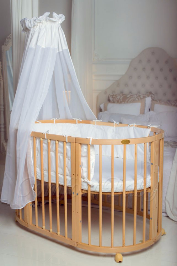 КРОВАТКА- ТРАНСФОРМЕР "COMFORT BABY" .Цена: 25 000 руб.  ХАРАКТЕРИСТИКИ:  возраст детей: 0-5 лет  габариты модели (Д х Ш х В): 1) колыбельки: 78*76*81 см  2) овальной кроватки: 128*76*81 cм  матрас приобретается отдельно.  максимальная нагрузка: 120 кг  Материал: изготавливается только из настоящего массива бука высшего сорта.  сборка: кровать в разобранном виде, простота сборки, инструкция по сборке на русском языке  продукция сертифицирована  производство: Россия  гарантия: 2 года   Дополнительные характеристики: 4 положения по высоте (расстояние положения дна от пола без колес: 1см, 12см, 37см, 57см; расстояние между отверстиями снизу-наверх: 12см, 15см, 20см.); 3 прутика - съемные.  КОНМПЛЕКТАЦИЯ:  1-я ступень - круглая кроватка  2-я ступень - овальная кроватка  3-я ступень - диванчик  4-я ступень - манеж  5-я и 6-я ступени - 2 кресла и столик  7-я ступень - пеленальный столик  ДОПОЛНИТЕЛЬНЫЕ ОПЦИИ:  Комплект постельный "Classic" +6950 руб.  Комплект постельный "Colorit" + 11990 руб.  Фирменный держатель для балдахина +790 руб.  Комплект цельных матрасов " Холкон"/ "Кокос" (круглый+овальный) +8490 руб  Маятник "ComfortBaby Pendulum" 2 в 1+6990 руб.